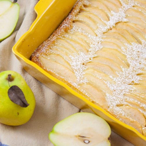 This is a picture of a pear clafoutis in a yellow baking dish