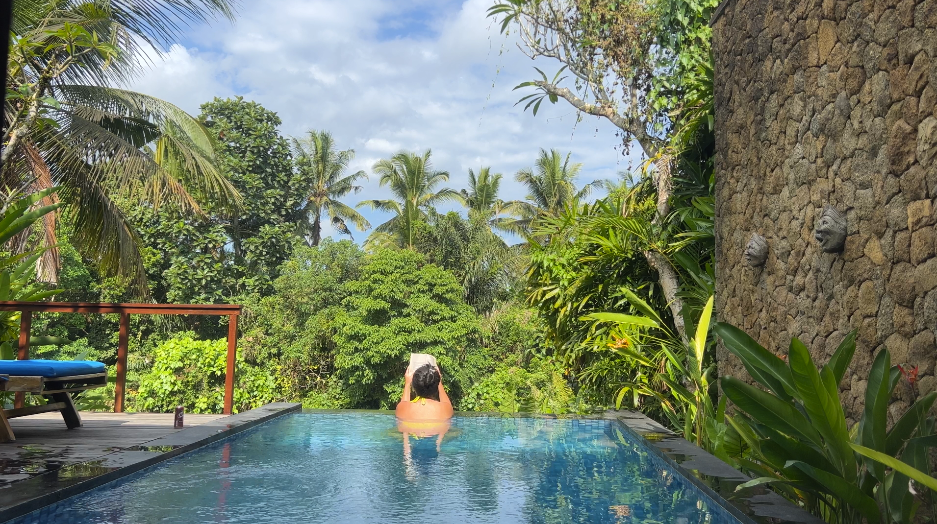 Relaxing in an Ubud, Bali villa pool with Bali's jungle forest in the background
